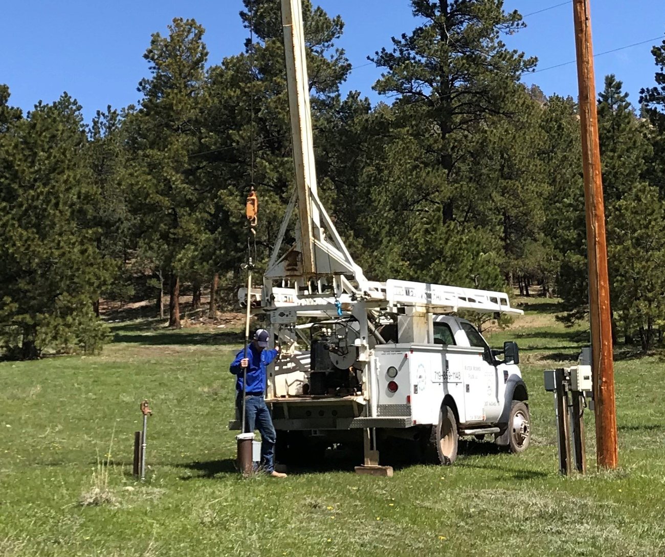Pump hoist truck set up over a well head